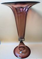 Full view of amethyst glass trumpet vase showing overall form and color