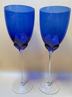Two cobalt blue wine glasses standing side by side