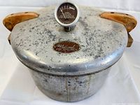 Full view of National aluminum pressure cooker with wooden handles and gauge