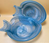 Pair of blue swirl glass bowls oblique view