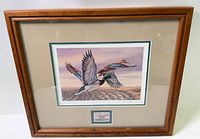 Front view of framed print showing artwork, matting, stamp vignette and wood frame