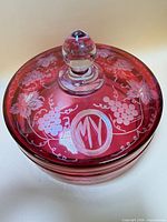 Top view of covered dish showing etched grapevine design and monogram