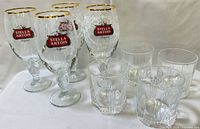 Four Stella Artois chalices and four Italian tumblers grouped together