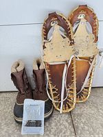 Boots, snowshoes and lace pack grouped