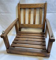 Front view showing slatted seat, back, armrests and eye bolts
