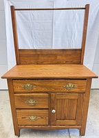 Front full view showing washstand, drawers, cabinet, backboard and towel rail