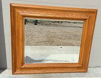 Front view of oak framed mirror showing frame color, grain and glass