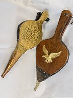 Both fireplace bellows front view showing designs and size relation