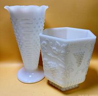 Both milk glass vases side by side