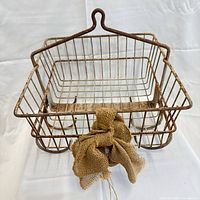 Front view showing shape, hook, burlap bow and rusted wire