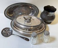Group view of casserole with lid, platter, vase, slotted spoon, and salt & pepper shakers