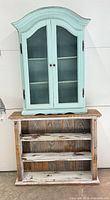 Mint cabinet stacked on distressed shelf showing full view of both pieces