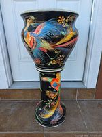 Full view of planter on pedestal showing hand-painted design