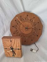 Front view of both clocks showing design and size comparison