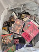 Open bag showing numerous cassette tapes with visible titles and cases