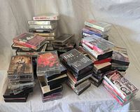 Overview of stacked cassette tapes on cloth backdrop