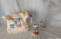 Front view showing vase, teapot and figurine together