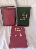 Front covers of all three hymnals showing titles