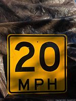 Front view of yellow reflective 20 MPH sign showing overall design and condition