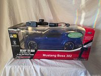 Boxed RC Mustang with controller mounted on top, full packaging visible