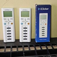 Front view two remotes and boxed remote