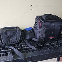 Three camera bags side by side on shelf
