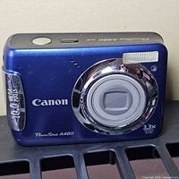 Front view showing lens, flash, color and model markings