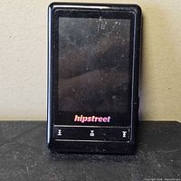 Front view showing screen, control buttons and logo