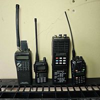Four handheld communication devices lined up to show size and type