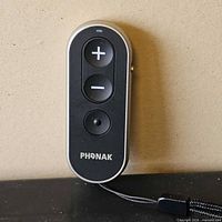 Front view of Phonak RemoteControl showing +, -, and program buttons