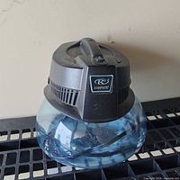 Front view of Rainbow RainMate showing water bowl and top housing