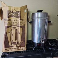 Coffee urn next to original box