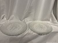 Two clear glass platters with embossed Christmas tree design