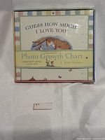 Front of boxed growth chart showing title, illustration, and sticker mention