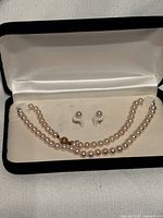 Pink pearl necklace, matching stud earrings, and presentation box