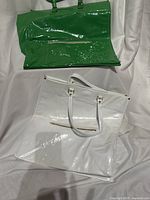 Front view of green and white tote bags on display