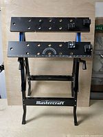 Front view of Mastercraft folding workbench showing clamping jaws, bench-dog holes and protractor scale