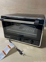 Front view of KitchenAid air fryer oven showing exterior condition and attached power cord