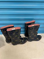 Four boots (two pairs) standing upright showing exterior horse pattern
