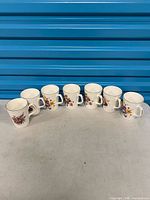 All seven floral bone china mugs lined in row
