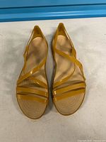 Top view of complete pair of yellow Crocs strappy sandals