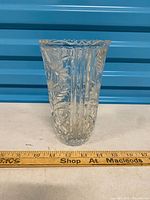 Front view showing floral relief and ruler for scale