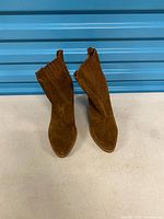 Front view of brown suede ankle boots