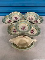 Set of bowls arranged with gravy boat and underplate