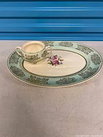 Platter and gravy boat front view showing pattern and colours