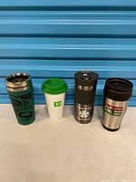 Group shot of all four travel mugs