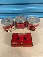 Front view of three IKEA glass jar candles with metal lids and Ashland Home votive candle box