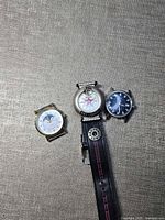 Three wristwatches: gold-tone Timex moonphase, Boy London with strap, silver-tone Timex black dial