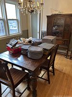 Dining table with four side chairs, buffet/china hutch in background