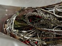 View into bag showing silver glittered sprays and red berry stems